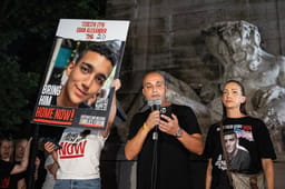 Adi Alexander speaks with Yael at his side, parents of Edan Alexander