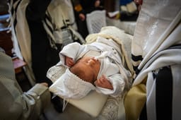 Rabbi's performing a Brit Milah, circumcision ceremony 