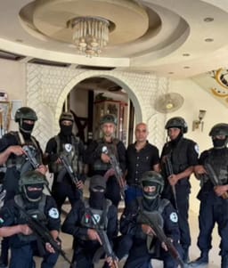 Abu Shabab’s militia members pose for a photo at the palace in Rafah that serves as their base.