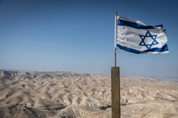 The Israeli flag with the Judean Desert, May 22, 2025. 