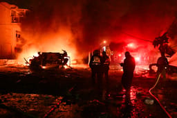 Israeli security and rescue forces at the scene where a ballistic missile fired from Iran hit and caused damage in Haifa, June 15, 2025.