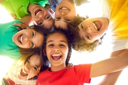 Bunch of cheerful joyful cute little children playing together
