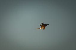 An Israeli Air Force fighter jet firing flares as it flies over the Gaza Strip, as it seen from the Israeli side of the border, July 20, 2025.