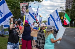 People protest in support of Israel and call for the release of hostages held in Gaza, while across the road pro-Hamas demonstrators rally in their support, in Toronto, Canada, August 31, 2025.