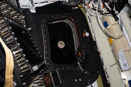The moon viewed through the window of Artemis II.