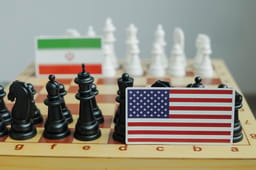 Flag of USA and a Iranian flag on chessboard. Conflict between those two countries.