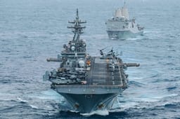 USS Boxer (LHD 4) and USS Portland (LPD 27) sail in formation while transiting the Indian Ocean,