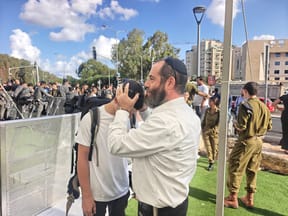 haredi man blesses his son at enlistment