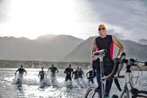 Triathlete swimmers emerging from water