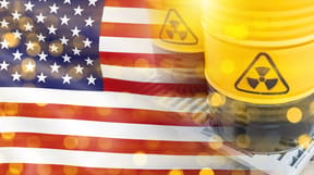 Radioactive fuel in barrels; USA flag