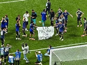 Argentina's national team with banner reading "Malvinas (Falkland Islands) are Argentine"