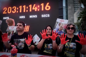 Families of Israelis held hostage by Hamas terrorists in Gaza attend a 'holiday" table calling for the release of the hostages, at "Hostage Square" in Tel Aviv, April 27, 2024.