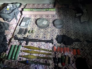 Weapons discovered in underground warehouse.