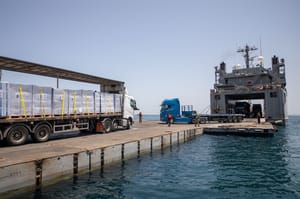 Aid offloading from the temporary pier before being damaged.
