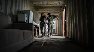 Security forces moving to arrest a terrorism suspect.