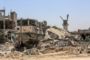 Palestinians gather after an Israeli military operation the Al-Qarara area in the city of Khan Younis in the southern Gaza Strip, on June 14, 2024.