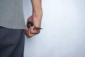 Illustrative: A person holding a pair of scissors