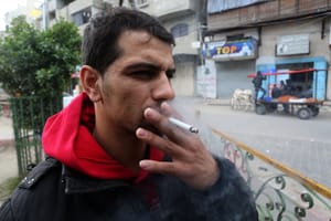 A Palestinian man selling cigarettes in his shop, at Rafah in southern Gaza Strip.                          