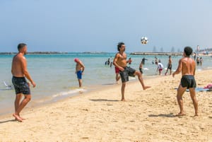 Israelis on the beach in Tel Aviv on a hot summer day on June 15, 2024. 