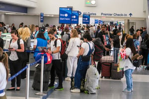 Holiday travelers wait in line to check-in at the Los Angeles International Airport