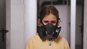 Girl wearing half gas mask respirator