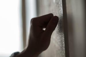 Hand knocking on the door