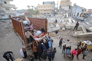 Palestinians moving around the ruins of Gaza City.