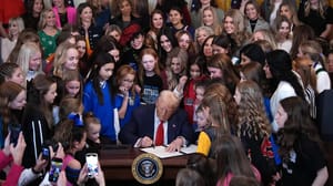 President Donald Trump joined by women athletes signs the “No Men in Women’s Sports” executive order in the East Room at the White House on Wednesday in Washington, DC