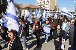 Mourners carrying Israeli flags