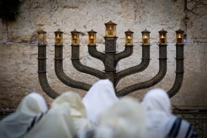 Ultra Orthodox Jews pray in front of the Menorah at the Western Wall 