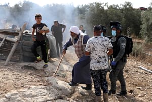 Israeli security forces argue with Palestinians as they arrive to demolish a house that was built without a permit in Yatta, Judea and Samaria