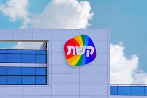 A sign with a Hebrew logo Keshet over on building TV Channel 12