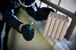 man lighting firecrackers, ahead of Purim, in the Northern Israeli city of Tzfat