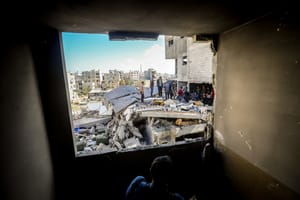 Palestinians inspect their homes after an Israeli airstrike in Al-Bureij camp.on Marsh 19, 2025. 