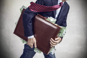Man carrying suitcase filled with cash