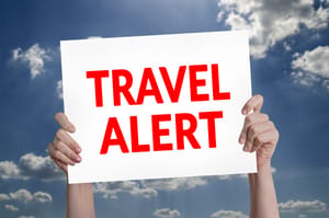 Travel Alert card with cloud background