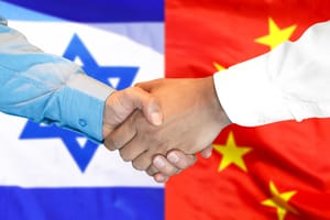 Handshake on the background of the China and Israel flag