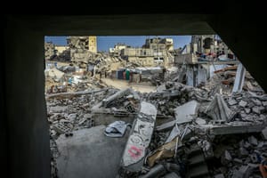 Palestinians inspect the rubble of the Ahmed family's home after it was bombed in an Israeli airstrike