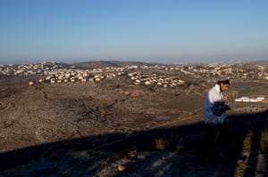 Young Jewish men seen outside the synagogue on the morning of the second day into the evacuation of the illegal outpost of Amona