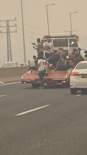 People being rescued from Road 1 on the back of lorry's to escape the fire