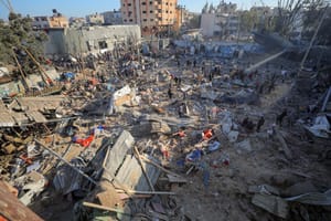 Palestinians at the site of an Israeli airstrike, in the Al-Bureij camp, in the Gaza Strip, May 7, 2025.