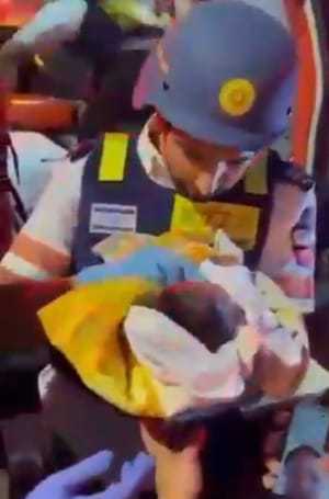 Magen David Adom Medics rescue 6 day old baby from the rubble after the Iran attack