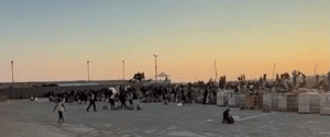 Gazans waiting for aid at a GHF station.