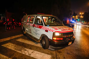 Israeli rescue and security forces at the scene where two teenage girls fell from the roof of a building in Rishon LeZion, central Israel, August 3, 2025.