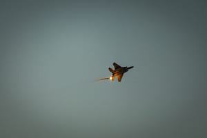 An Israeli Air Force fighter jet firing flares as it flies over the Gaza Strip, as it seen from the Israeli side of the border, July 20, 2025.
