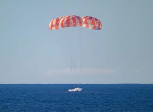 The Orion capsule entering the water upon returning to Earth.