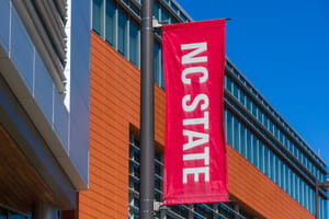 An NC State banner flying on the university's Raleigh campus.