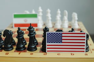 Flag of USA and a Iranian flag on chessboard. Conflict between those two countries.