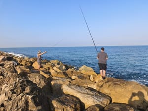 Fishermen fish on Tel Aviv separate beach