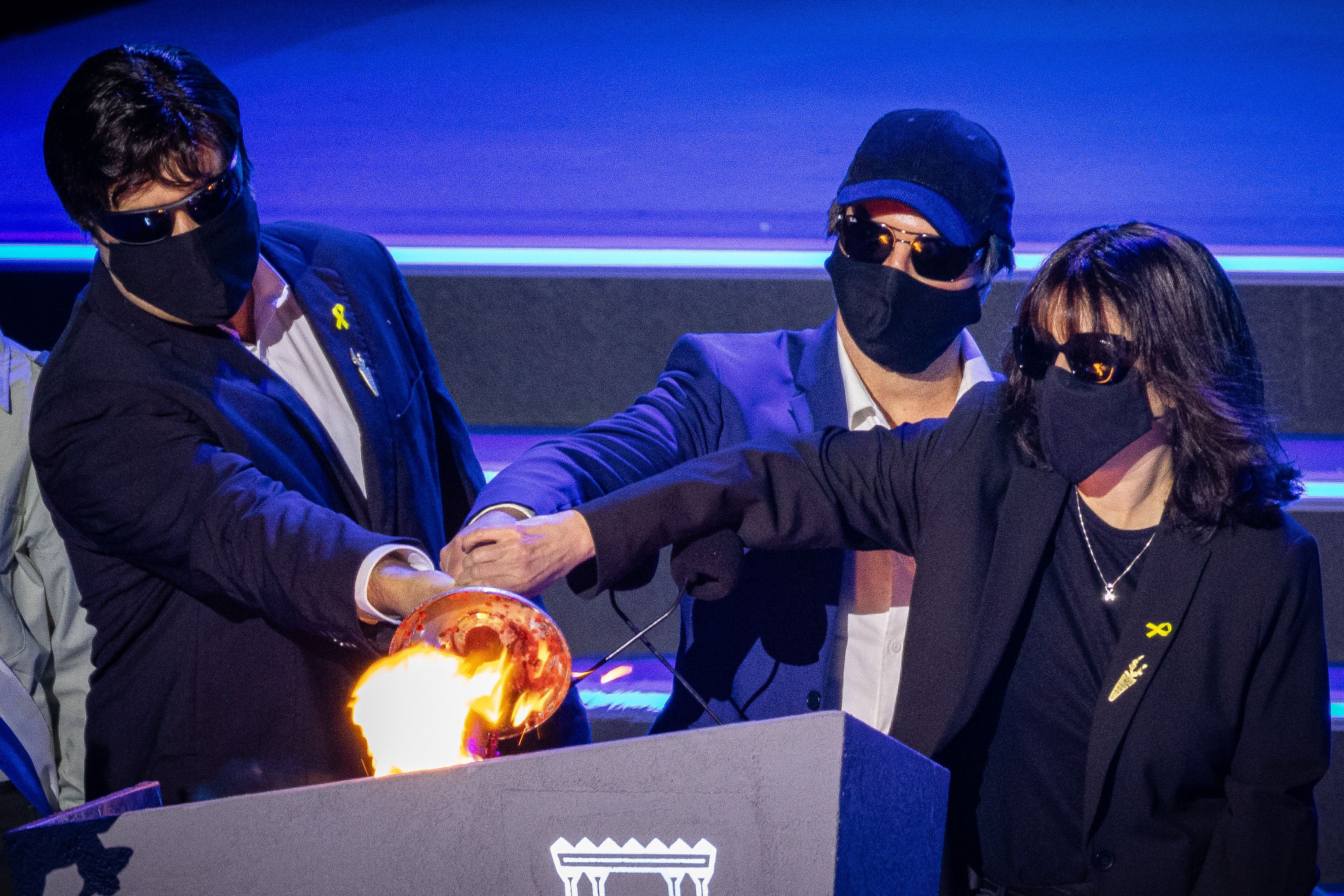 Three Mossad operatives who led the beeper operation in Lebanon light the torch during the main rehearsal of the 77th anniversary Independence Day ceremony, held at Mount Herzl, Jerusalem, on April 28, 2025. 